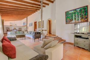 a living room with a couch and a tv at Finca Ranchon Grande by Rentallorca in El Port