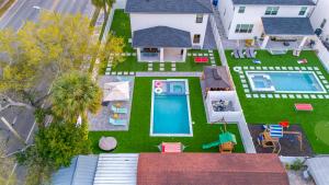 an aerial view of a house with a yard with a swimming pool at Luxury Modern Villa w Pool Jacuzzi Amenities in Tampa