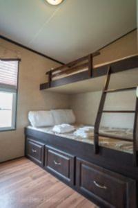a room with a bed with two bunk beds at 2 Bedroom Harbor Front Cottage 2 in Roseneath