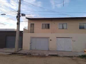 a house with two garage doors and a pole at Casa Central em Petrolina in Petrolina