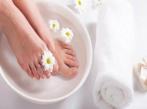a woman with flowers on her feet in a bath tub at Minh Minh Hotel & Spa in Da Nang