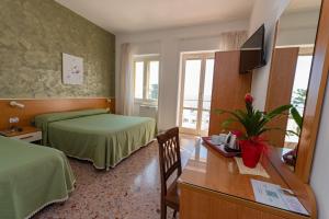 Postel nebo postele na pokoji v ubytování Hotel Baia Verde