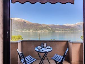 a table and chairs on a balcony with a view of a lake at Apartment Daniela by Interhome in Dorio +19 photos