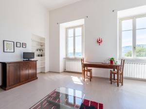 a living room with a wooden table and a desk at Apartment Gardenia by Interhome in Verbania