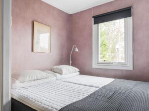a bedroom with two beds and a window at Holiday Home Smultronstället by Interhome in Stavsnäs