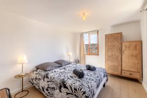 a bedroom with a bed and two lamps and a window at Olive- Vaste appartement donnant sur la Sorgue in LʼIsle-sur-la-Sorgue