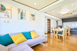a living room with a couch and a table at Near Shibuya! 150 sq m Private floor & Japanese garden in Tamagawa