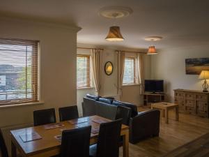 a living room with a table and a dining room at 17 Canons Lane in Clifden