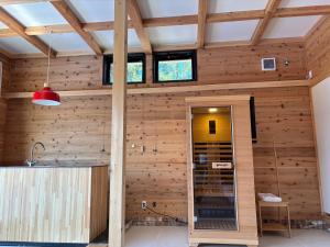 a room with wooden walls and a ceiling with windows at Kita Karuizawa Morino Takibi NO7 Sauna Sweet in Tsumagoi