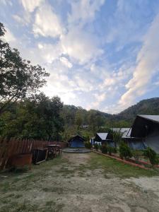 a backyard with a fence and a table and tents at Nama Stay Home in Pokhara