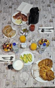 a table topped with plates of food and fruit at Albergue Mar del Plata in Finisterre