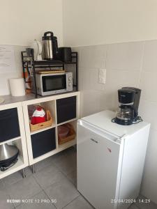 a kitchen with a refrigerator and a microwave at Maison au coeur d'Orly in Orly +4 photos