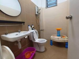 a bathroom with a sink and a toilet and a mirror at PlayHouse Fun4Kids 22pax 6R5B in Melaka +45 photos