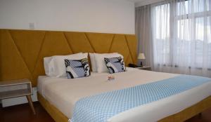 Postel nebo postele na pokoji v ubytování Pop Art Hotel Las Colinas Manizales + 37 fotografií