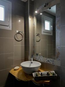 a bathroom with a sink and a mirror at Dionisos Hotel in Nei Poroi