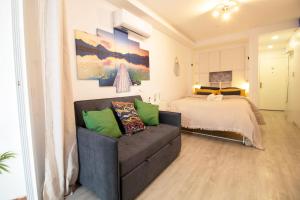 a living room with a couch and a bed at ELEVANA in Fuengirola