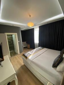a bedroom with a large bed and a table at Florya House Hotel in Istanbul