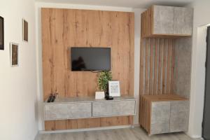 a living room with a tv on a wooden wall at Villa Castella in Skopje