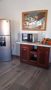 a kitchen with a stainless steel refrigerator and a counter at GR20acd Mary in Cuauhtémoc