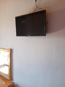 a flat screen tv hanging on a wall at Magdalini Studio in Anaxos