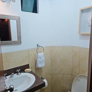 a bathroom with a sink and a toilet at Departamento Acogedor in Lima