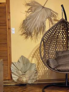 a hanging hammock chair with a flower on the floor at TREE House-Old Town Brașov in Braşov