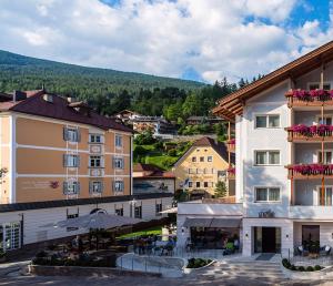 a view of a town with buildings and trees at Apartment Genziana in Ortisei