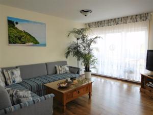 a living room with a couch and a coffee table at Komfortferienwohnung Kreideblick in Sassnitz