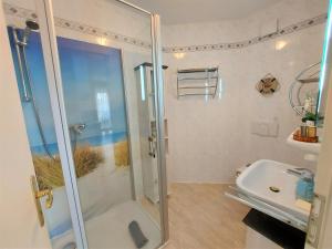 a bathroom with a shower and a sink at Komfortferienwohnung Kreideblick in Sassnitz +6 photos