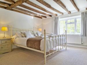 a bedroom with a large bed and a window at The Milk House in Ashurst