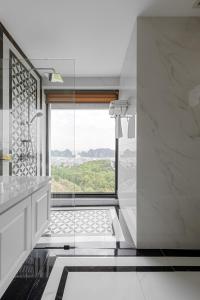 a bathroom with a large window and a shower at Villa Hạ Long Gần Biển in Ha Long