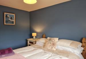 A bed or beds in a room at Cushatrough Claddaghduff