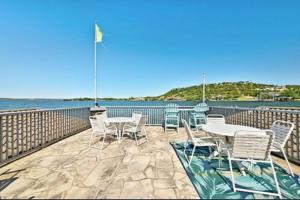 a patio with tables and chairs and the water at Stunning Waterfront Property Sleeps 12+ in Horseshoe Bay