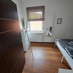 a room with a bed and a window and a door at Ferienwohnung Paulus in Albstadt
