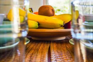 a bowl of fruit on top of a wooden table at Kroussos Cottage in Faraklata