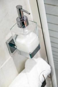 a glass soap dispenser on a toilet in a bathroom at Stylish Studio 5 - City Centre Coach Station in Birmingham