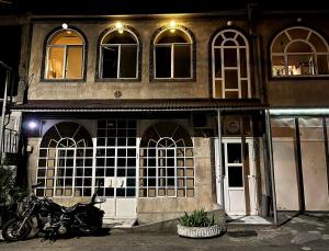 a motorcycle parked in front of a building at night at Econom Hostel in Yerevan