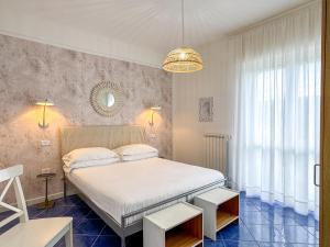 a bedroom with a white bed and a large window at Tenuta dei Normanni in Salerno
