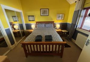 a bedroom with a bed with two tables and two lamps at North Lodge Kilmun in Kilmun