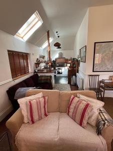 a living room with a couch and a kitchen at North Lodge Kilmun in Kilmun