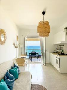 a kitchen and living room with a view of the ocean at Appartamenti Vacanze Villa Meo in Villafranca Tirrena