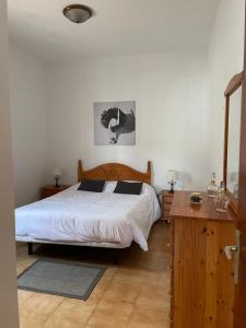 Casa Don Daniel في Buzanada: غرفة نوم بسرير كبير مع اللوح الخشبي