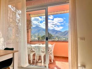 a dining room with a table and chairs and a window at Le 3 case di Mia in Marciana Marina