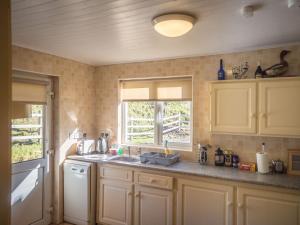 a kitchen with a sink and a window at Lough Fee Renvyle in Renvyle