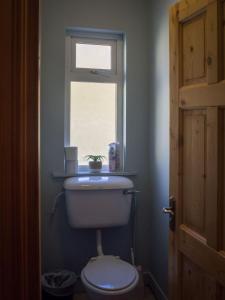 a bathroom with a toilet and a window at Lough Fee Renvyle in Renvyle