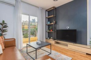 a living room with a large flat screen tv at Alice 2-BR in Mar Mikhael in Beirut