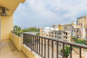a balcony with a view of a city at Alice 2-BR in Mar Mikhael in Beirut