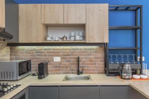 a kitchen with a sink and a brick wall at Alice 2-BR in Mar Mikhael in Beirut +14 photos