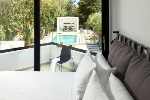 a balcony with a view of a swimming pool at MichELe Luxury apartments by Smaris Collection in Malia