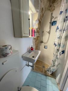 a bathroom with a sink and a toilet and a shower at Casa Mimmo in Ostuni